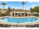 Community pool features a covered area with tables and chairs for residents at 10154 Regent Square Dr # 201, Orlando, FL 32825