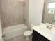 Clean, tiled bathroom with a shower-tub combination and a vanity with storage at 1030 Teal Creek Dr, St Cloud, FL 34771