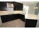 Modern kitchen with stainless steel hood, dark cabinetry, quartz countertops, and eat-in island at 1030 Teal Creek Dr, St Cloud, FL 34771