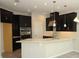 Modern kitchen with black cabinetry, stainless steel appliances, and a breakfast bar at 1030 Teal Creek Dr, St Cloud, FL 34771