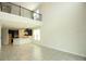 Open living space featuring tile floors, soaring ceilings, and view of the modern kitchen at 1030 Teal Creek Dr, St Cloud, FL 34771