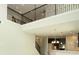 Living area featuring high ceilings, staircase, dark wood railing, and open-concept kitchen at 1030 Teal Creek Dr, St Cloud, FL 34771