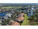 Aerial view of a residential area featuring beautiful houses, a lake, and a golf course at 10339 Kensington Shore Dr # J-202, Orlando, FL 32827