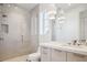 Bright bathroom featuring a glass shower, white cabinets, and sleek hardware fixtures at 10339 Kensington Shore Dr # J-202, Orlando, FL 32827