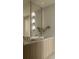 Stylish bathroom featuring double sinks with marble countertops, wood cabinets and modern lighting at 10339 Kensington Shore Dr # J-202, Orlando, FL 32827