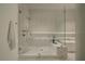Contemporary bathroom featuring a glass shower enclosure, a soaking tub, and elegant marble accents at 10339 Kensington Shore Dr # J-202, Orlando, FL 32827