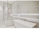 Luxurious bathroom with a modern soaking tub, glass-enclosed shower, and marble accents at 10339 Kensington Shore Dr # J-202, Orlando, FL 32827
