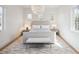 Bright bedroom with a large window, neutral tones, modern lighting, and elegant furniture at 10339 Kensington Shore Dr # J-202, Orlando, FL 32827