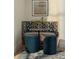 Cozy breakfast nook featuring a round table, upholstered seating, and blue ottomans for a stylish dining experience at 10339 Kensington Shore Dr # J-202, Orlando, FL 32827