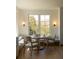 Bright breakfast nook features a built-in bench, round table, and natural light from a large window at 10339 Kensington Shore Dr # J-202, Orlando, FL 32827