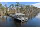 Aerial view of a waterfront gazebo dock on a peaceful lake surrounded by beautiful trees at 10339 Kensington Shore Dr # J-202, Orlando, FL 32827