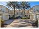 Elegant home with charming curb appeal, featuring a brick driveway and well-manicured landscaping and gorgeous palm trees at 10339 Kensington Shore Dr # J-202, Orlando, FL 32827