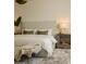 Serene main bedroom showcasing a plush bed, stylish decor, and a cozy sitting bench at 10339 Kensington Shore Dr # J-202, Orlando, FL 32827