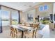 Open-concept living space with high ceilings, dining area, and seamless flow to the outdoors at 1042 Teal Creek Dr, St Cloud, FL 34771