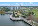 A scenic aerial view of lakeside apartments next to a decorative pier adorned with landscaping at 109 Oyster Bay Cir # 150, Altamonte Springs, FL 32701