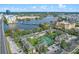 An aerial view highlighting the apartment's tennis courts and lush surroundings near a scenic lake at 109 Oyster Bay Cir # 150, Altamonte Springs, FL 32701