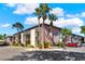Apartment building exterior with palm trees, well maintained landscaping, and ample parking at 109 Oyster Bay Cir # 150, Altamonte Springs, FL 32701