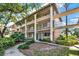 Charming condo building with multiple levels, exterior walkways, and lush landscaping at 109 Oyster Bay Cir # 150, Altamonte Springs, FL 32701