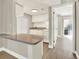 An open kitchen features white cabinets and white appliances at 109 Oyster Bay Cir # 150, Altamonte Springs, FL 32701