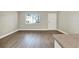 Cozy living room with wood-look flooring, a window, and neutral wall paint at 109 Oyster Bay Cir # 150, Altamonte Springs, FL 32701