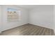 An empty bedroom with a window with blinds and vinyl floors at 1135 Marni Ridge Ct, Kissimmee, FL 34747