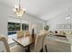 Bright dining area with views of the pool, luxury vinyl flooring, and stylish chandelier at 1135 Marni Ridge Ct, Kissimmee, FL 34747