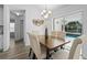 Elegant dining area with stylish furnishings, decor, and a view of the pool through the sliding doors at 1135 Marni Ridge Ct, Kissimmee, FL 34747
