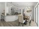 Bright dining area featuring stylish chandelier, table with seating for four, and an adjacent kitchen at 1135 Marni Ridge Ct, Kissimmee, FL 34747