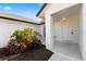 Close-up of front porch with manicured landscaping and modern door at 1135 Marni Ridge Ct, Kissimmee, FL 34747