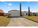 Charming single-story home with a wide driveway and manicured landscaping at 1135 Marni Ridge Ct, Kissimmee, FL 34747