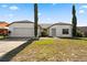 Charming single-story home showcasing a well-manicured lawn and a two-car garage at 1135 Marni Ridge Ct, Kissimmee, FL 34747