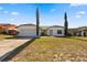 Well-maintained single-story house featuring a two-car garage and green lawn at 1135 Marni Ridge Ct, Kissimmee, FL 34747