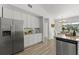 Modern kitchen features stainless steel appliances, ample storage, and eat-in dining area at 1135 Marni Ridge Ct, Kissimmee, FL 34747