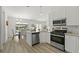 Bright kitchen with stainless appliances, light cabinetry, and views of the dining area and outdoor pool at 1135 Marni Ridge Ct, Kissimmee, FL 34747