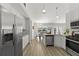 Well-lit kitchen with stainless steel appliances, light countertops and a view into the dining room at 1135 Marni Ridge Ct, Kissimmee, FL 34747