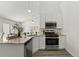 Modern kitchen with white cabinets, granite countertops, and stainless steel appliances at 1135 Marni Ridge Ct, Kissimmee, FL 34747