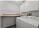 Laundry room with washer, dryer, upper cabinets, and countertop space at 1135 Marni Ridge Ct, Kissimmee, FL 34747