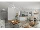 Open-concept living space with modern furnishings, granite counters, and a view of the kitchen and dining area at 1135 Marni Ridge Ct, Kissimmee, FL 34747