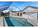 Enclosed pool and spa area with backyard views at 1135 Marni Ridge Ct, Kissimmee, FL 34747