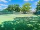 Community tennis court with green surface, net, and fencing, ideal for recreational play and sports enthusiasts at 1135 Marni Ridge Ct, Kissimmee, FL 34747