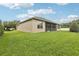 Lush green backyard with well-maintained lawn and partial view of the home's exterior at 11725 Verrazano Dr, Orlando, FL 32836