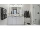 Modern bathroom with double sink vanity, a large mirror, and a glass-enclosed shower at 11725 Verrazano Dr, Orlando, FL 32836