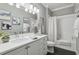 Bright bathroom featuring a modern vanity, framed art, and a tub with a shower and white tile at 11725 Verrazano Dr, Orlando, FL 32836