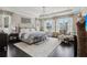 Bright bedroom with a dark wood floor, complemented by a chandelier and light-colored, decorative curtains at 11725 Verrazano Dr, Orlando, FL 32836