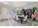 Elegant dining room with a chandelier, wainscoting, and ample natural light at 11725 Verrazano Dr, Orlando, FL 32836