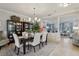 Open-concept dining area flowing into a living room, featuring stylish decor and natural light at 11725 Verrazano Dr, Orlando, FL 32836
