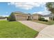 Charming single-story home features a spacious driveway and well-manicured lawn at 11725 Verrazano Dr, Orlando, FL 32836