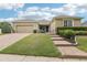 Charming single-story home featuring a well-manicured lawn, brick driveway, and welcoming curb appeal at 11725 Verrazano Dr, Orlando, FL 32836