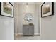 Well-lit hallway with stylish cabinet and a decorative mirror at 11725 Verrazano Dr, Orlando, FL 32836