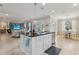 Open kitchen concept with island seating, stainless appliances, and easy access to dining and living areas at 11725 Verrazano Dr, Orlando, FL 32836